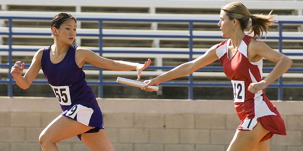 Photo of relay racers smoothly handing off the baton illustrates the value of the fundraising communications alignment tool.