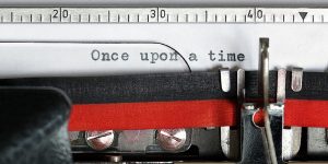 Closeup of old fashioned typewriter with the words once upon a time on the paper depicts nonprofit storytelling tool.