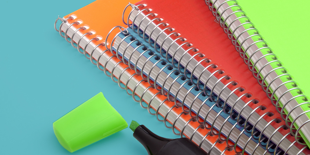 Colorful spiral notebooks and highlighter pen symbolize our nonprofit editorial guidelines template.