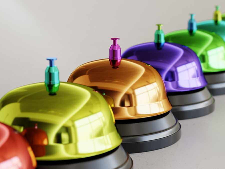 Line of vibrantly colored reception bells illustrate our custom nonprofit communications services.