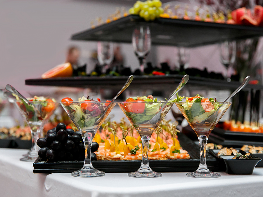 Beautifully decorated catering banquet table with canape, vegetables, and fruit illustrates special events