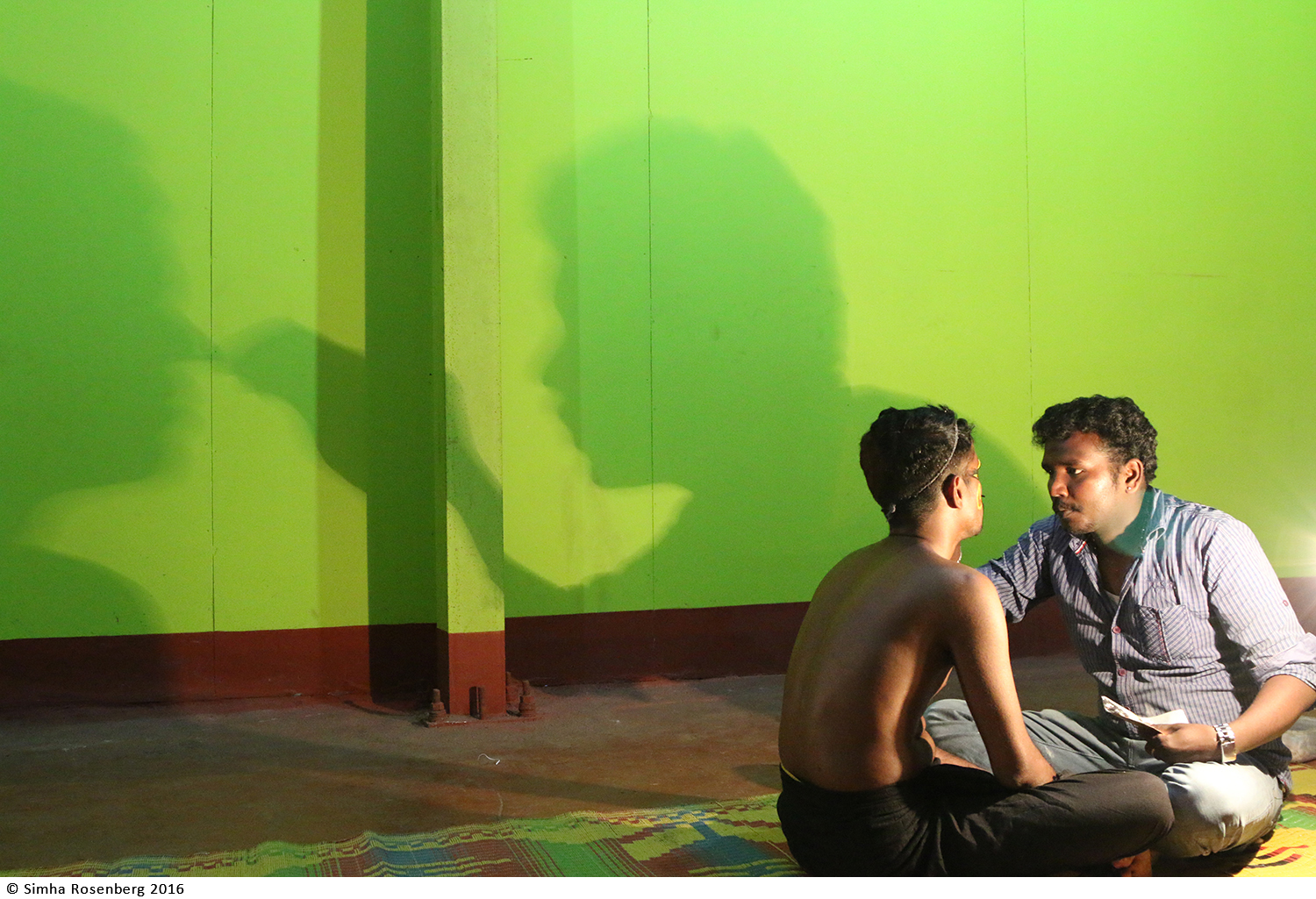 Photo of Kathakali storytellers applying makeup before a performance depicts the power of stories and nonprofit storytelling.